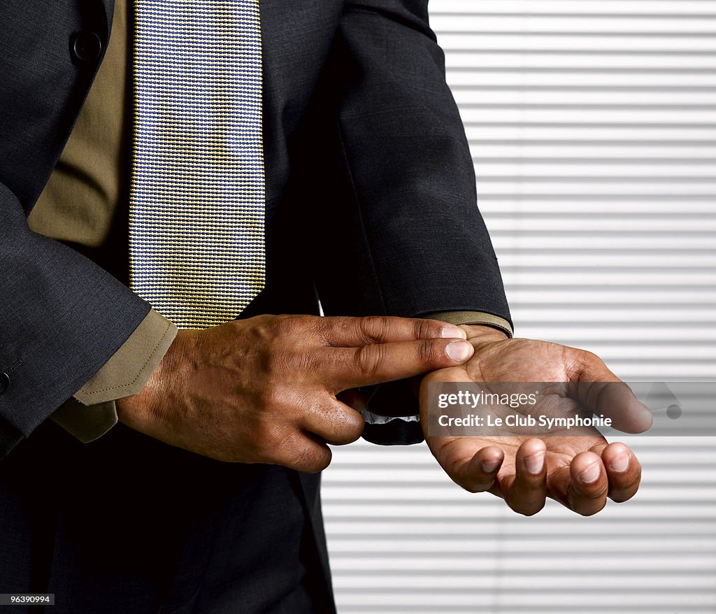 Business man with finger on pulse