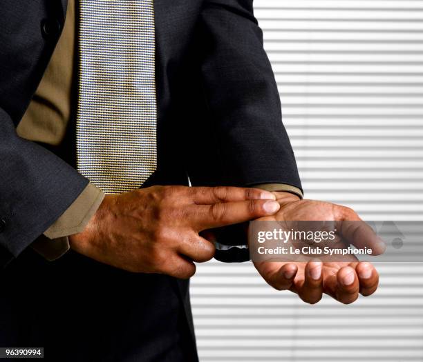 business man with finger on pulse - hypochondria stock pictures, royalty-free photos & images