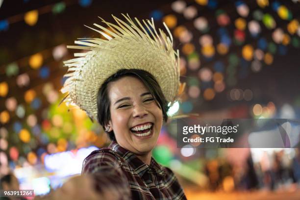 young woman enjoying a great time in the famous brazilian junina party (festa junina) - caipira style - hispanic month stock pictures, royalty-free photos & images