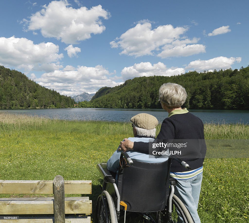 Senior couple relaxing by lake