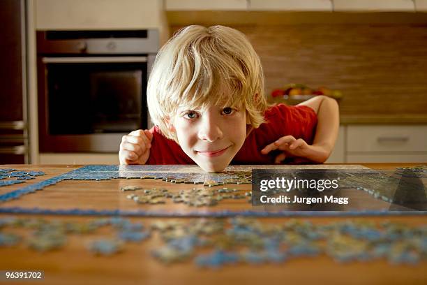 portrait of a boy with a puzzle - jigsaw piece stock photos et images de collection