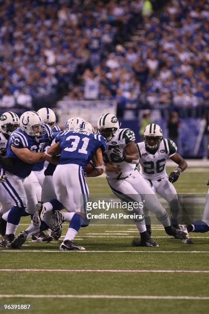 Running Back Donald Brown of the Indianapolis Colts is stopped by Linebacker David Harris of the New York Jets when the Indianapolis Colts host the...