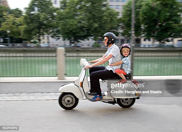 father and son on scooter - scooter stockfoto's en -beelden