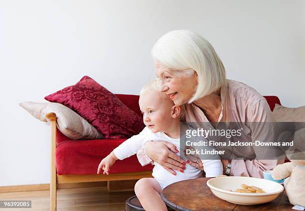 a grandmother talking to her grandson - chelsea pensionär stock-fotos und bilder