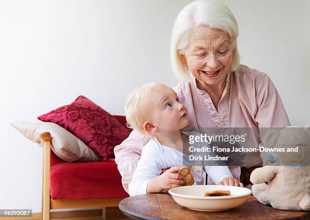 a grandmother talking to her grandson - chelsea pensionär stock-fotos und bilder