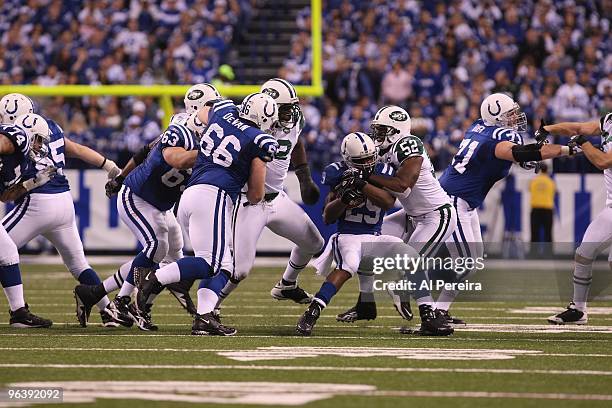 Running Back Joseph Addai of the Indianapolis Colts is stopped by Linebacker David Harris of the New York Jets when the Indianapolis Colts host the...