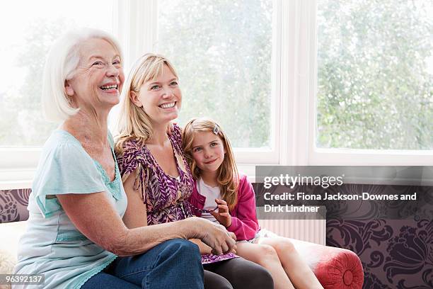 a grandmother, mother and daughter - chelsea pensionär stock-fotos und bilder