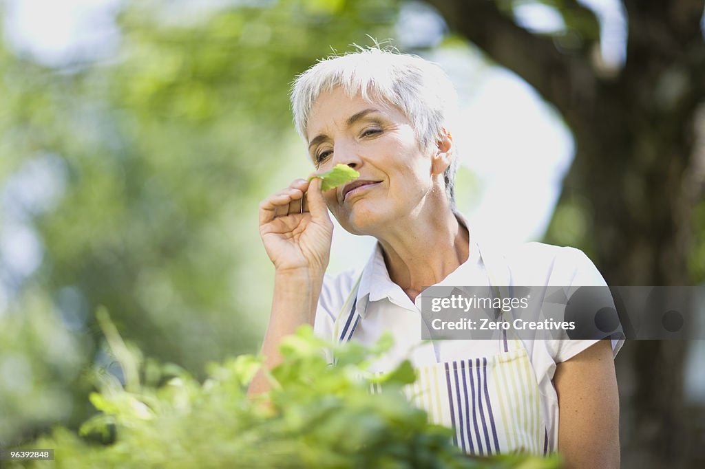 Woman taking a smell at some herbs