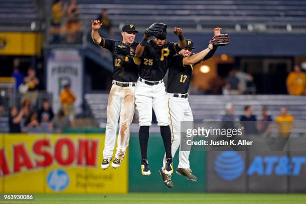 Corey Dickerson, Gregory Polanco and Austin Meadows of the Pittsburgh Pirates celebrate after defeating the Chicago Cubs 2-1 at PNC Park on May 30,...