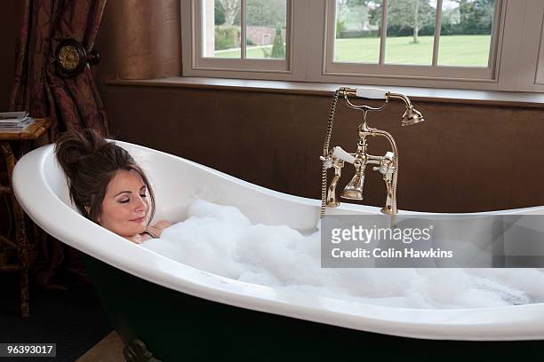 woman relaxing in luxury bath - schaumbad stock-fotos und bilder