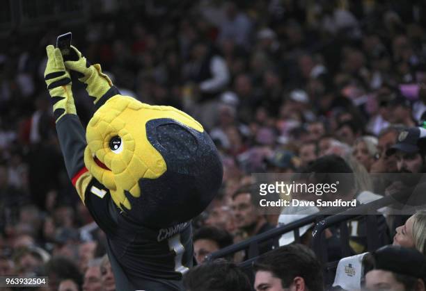 The Vegas Golden Knights mascot, Chance, takes a selfie with fans during the second period Game Two of the 2018 NHL Stanley Cup Final between the...