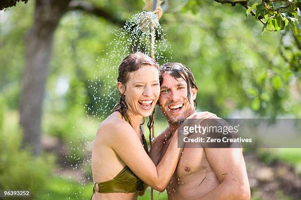 man and woman in nature - shower man woman washing stock pictures, royalty-free photos & images