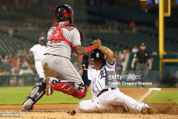 JaCoby Jones of the Detroit Tigers slides under the tag of Martin Maldonado of the Los Angeles Angels to score in the fifth inning at Comerica Park...
