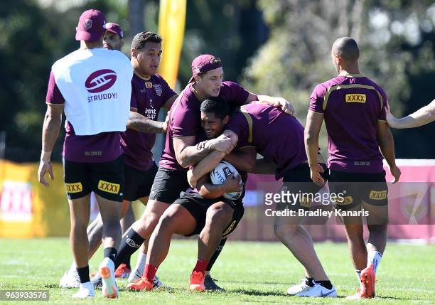 Anthony Milford is tackled by Jarrod Wallace during a Queensland Maroons training session at Sanctuary Cove on May 31, 2018 at the Gold Coast,...
