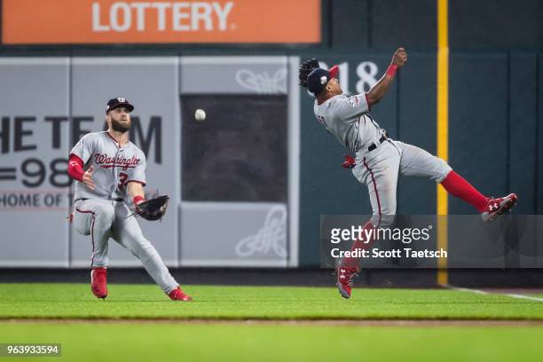 Wilmer Difo of the Washington Nationals and Bryce Harper try to catch a fly ball hit by Adam Jones of the Baltimore Orioles during the ninth inning...