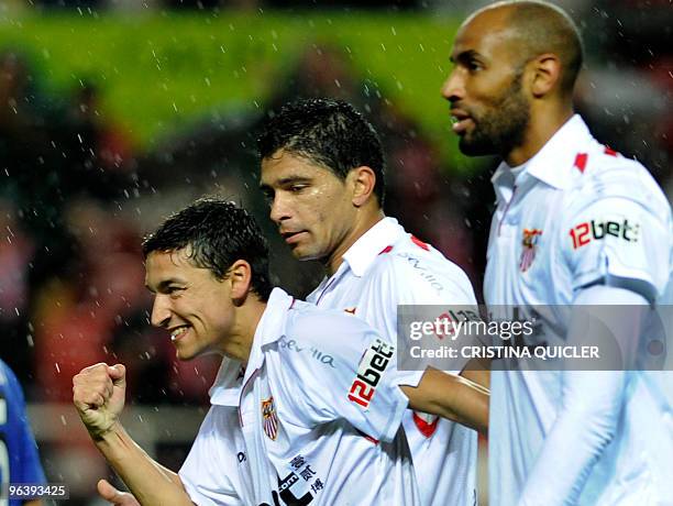 Sevilla's midfielder Jesus Navas celebrates after scoring against Getafe with Sevilla's Malian forward Frederic Kanoute and Sevilla's Brazilian...
