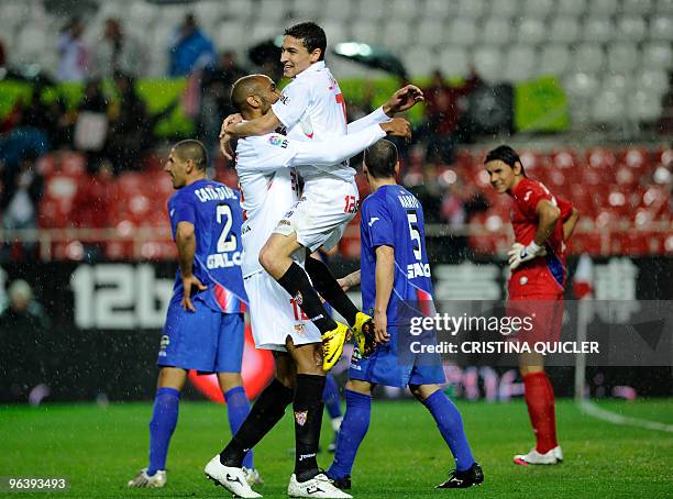 Sevilla's midfielder Jesus Navas celebrates after scoring with Sevilla's Malian forward Frederic Kanoute against Getafe during a Spanish King�s Cup...