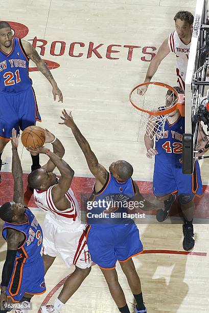 Carl Landry of the Houston Rockets puts up a shot against Nate Robinson and Jonathan Bender of the New York Knicks during the game on January 9, 2010...