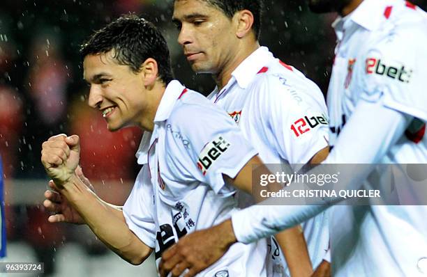 Sevilla's midfielder Jesus Navas celebrates after scoring against Getafe with Sevilla's Malian forward Frederic Kanoute and Sevilla's Brazilian...