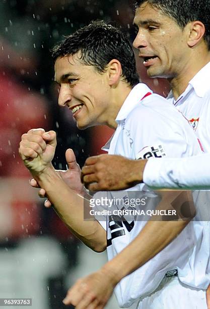 Sevilla's midfielder Jesus Navas celebrates after scoring against Getafe with Sevilla's Brazilian midfielder Renato during a Spanish King�s Cup...