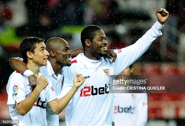 Sevilla's midfielder Jesus Navas celebrates after scoring against Getafe with Sevilla's midfielder from Ivory Coast Christian Ndri Romaric and...