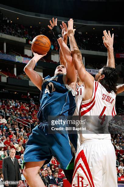 Kevin Love of the Minnesota Timberwolves puts up a shot against Luis Scola of the Houston Rockets during the game on January 13, 2010 at the Toyota...