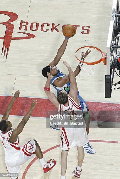 Ryan Gomes of the Minnesota Timberwolves lays up a shot against David Andersen of the Houston Rockets during the game on January 13, 2010 at the...