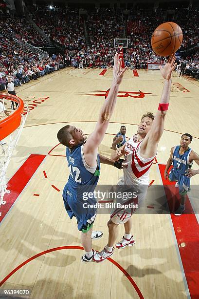 David Andersen of the Houston Rockets lays up a shot against Kevin Love of the Minnesota Timberwolves during the game on January 13, 2010 at the...