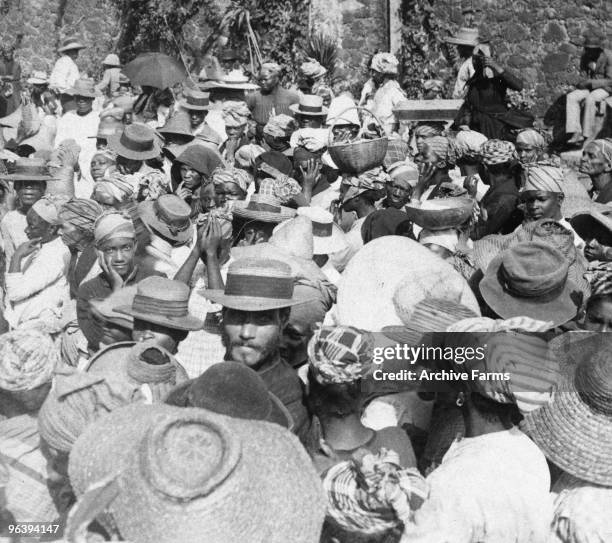 Distributing relief supplies to refugees fleeing after the eruption of the Mount Pelee volcano on May 10, 1902 at St. Pierre, Martinique.