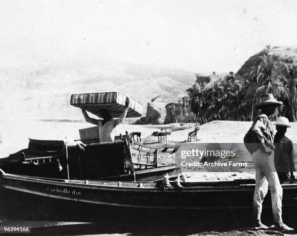 Refugees fleeing after the eruption of the Mount Pelee volcano load furniture on boats on May 10, 1902 at St. Pierre, Martinique.