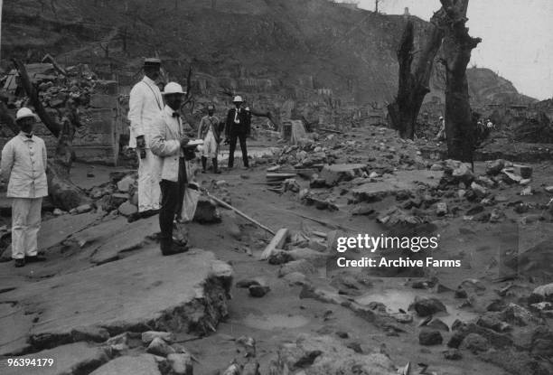 Scientists and naval officers explore the ruins of St. Pierre after the eruption of the Mount Pelee volcano on May 10, 1902 at St. Pierre, Martinique.