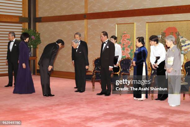 Vietnamese President Tran Dai Quang, his wife Nguyen Thi Hien, Emperor Akihito and Empress Michiko welcome Japanese Prime Minister Shinzo Abe and his...