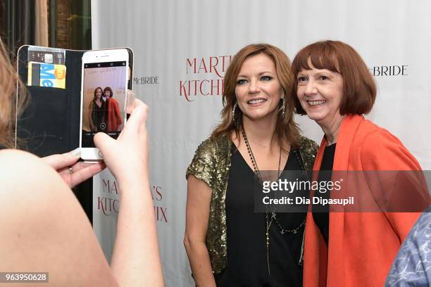 Martina McBride poses with a guest at Martina McBride Announces Forthcoming Cookbook "Martina's Kitchen Mix" at Chef's Club on May 30, 2018 in New...