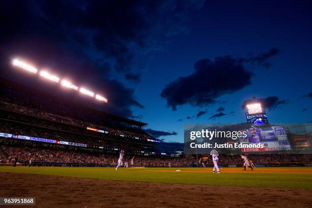 Carlos Gonzalez of the Colorado Rockies and starting pitcher Derek Holland of the San Francisco Giants react after Gonzalez lined out to center field...