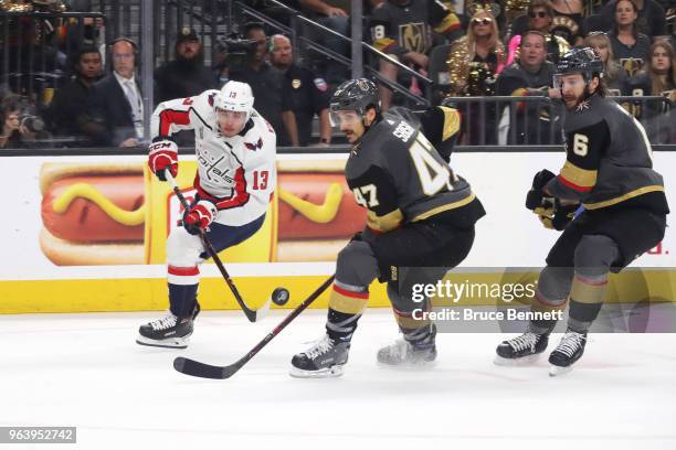 Jakub Vrana of the Washington Capitals handles the puck against Luca Sbisa and Colin Miller of the Vegas Golden Knights in Game Two of the 2018 NHL...