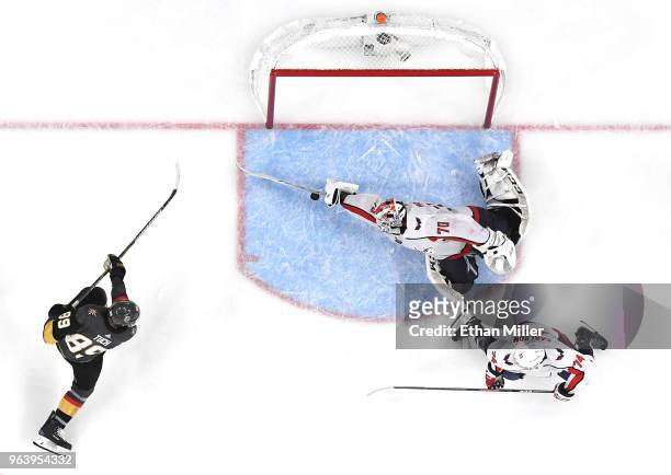Braden Holtby of the Washington Capitals makes a diving stick save on a shot by Alex Tuch of the Vegas Golden Knights as John Carlson of the Capitals...