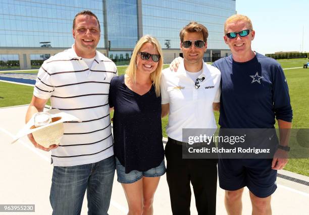 Billy Cannon, Liz Power; Indianapolis 500 Champion Will Power and Dallas Cowboys head coach Jason Garrett pose for a photo after practice at The Ford...