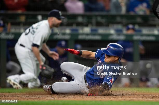 Shin-Soo Choo of the Texas Rangers slides safely home on single by Nomar Mazara of the Texas Rangers off of relief pitcher Marc Rzepczynski of the...