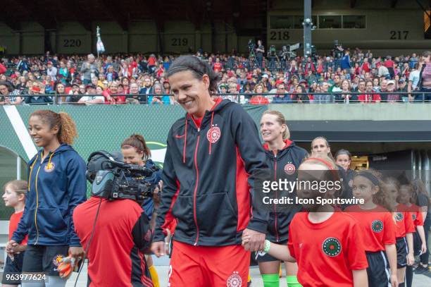 Portland Thorns forward Christine Sinclair and Utah Royals midfielder Desiree Scott lead their teams to the pitch moments before the Portland Thorns...