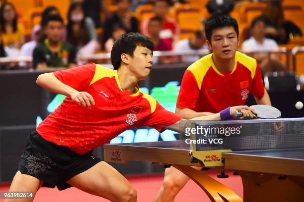 Fan Zhendong and Lin Gaoyuan of China compete in the Men's Doubles first round match against Lam Siu Hang and Ng Pak Nam of Hong Kong during day one...