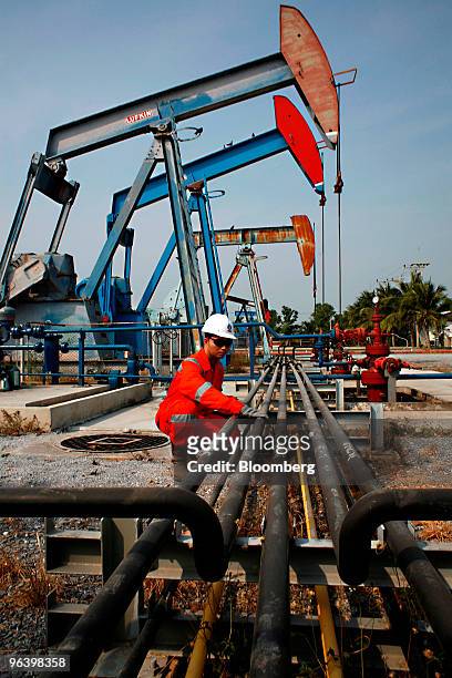 Exploration & Production Pcl production operator Kowan Boonruangjal checks a pipe that carries crude oil to the storage tanks at PTTEP 1 Project...