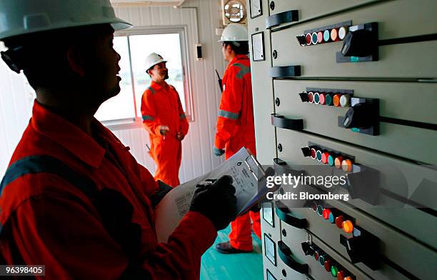 Exploration & Production Pcl production operators Kowan Boonruangjal, left, Narongrit Wankorn, center, and Kiattikul Roumsuk work in the control...