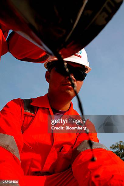 Exploration & Production Pcl production operator Kowan Boonruangjal looks on as a sample of crude oil is collected for analysis from the storage...