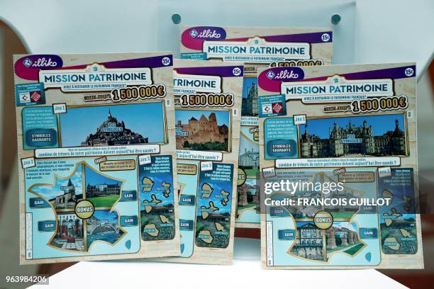 Picture taken on May 30, 2018 at the headquarters of Francaise des Jeux , operator of France's national lottery games, shows scratch cards with...