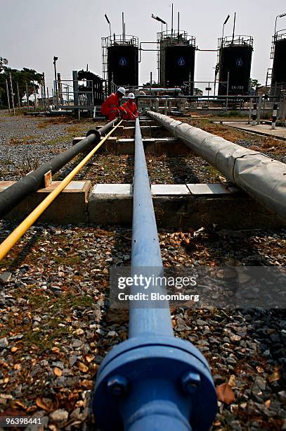 Exploration & Production Pcl production operators work on a pipe that carries crude oil to the storage tanks at PTTEP 1 Project site's U-Thong...