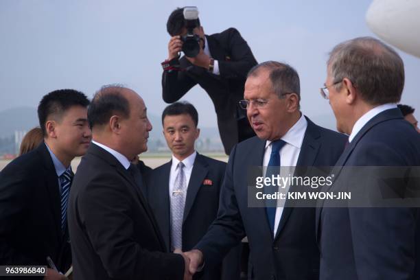 Russia's Foreign Minister Sergei Lavrov shakes hands with North Korea's Vice Foreign Minister Sin Hong Chol at the Pyongyang International Airport on...