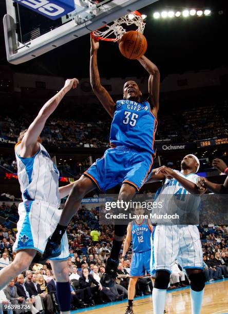 Kevin Durant of the Oklahoma City Thunder dunks against Darius Songaila and James Posey of the New Orleans Hornets on February 3, 2010 at the New...