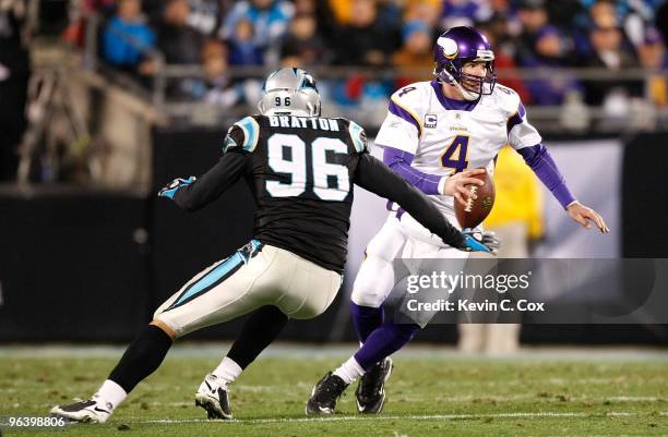 Quarterback Brett Favre of the Minnesota Vikings against Tyler Brayton of the Carolina Panthers at Bank of America Stadium on December 20, 2009 in...