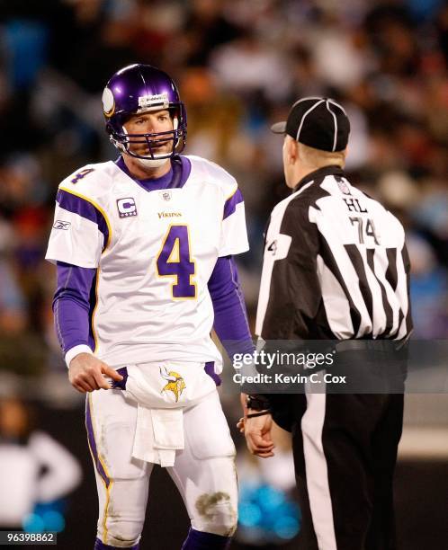 Head linesman Derick Bowers converses with quarterback Brett Favre of the Minnesota Vikings against the Carolina Panthers at Bank of America Stadium...