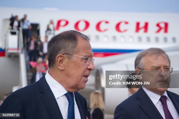 Russia's Foreign Minister Sergei Lavrov walks with Russia's Ambassador to North Korea Alexander Matsegora at Pyongyang International Airport on May...